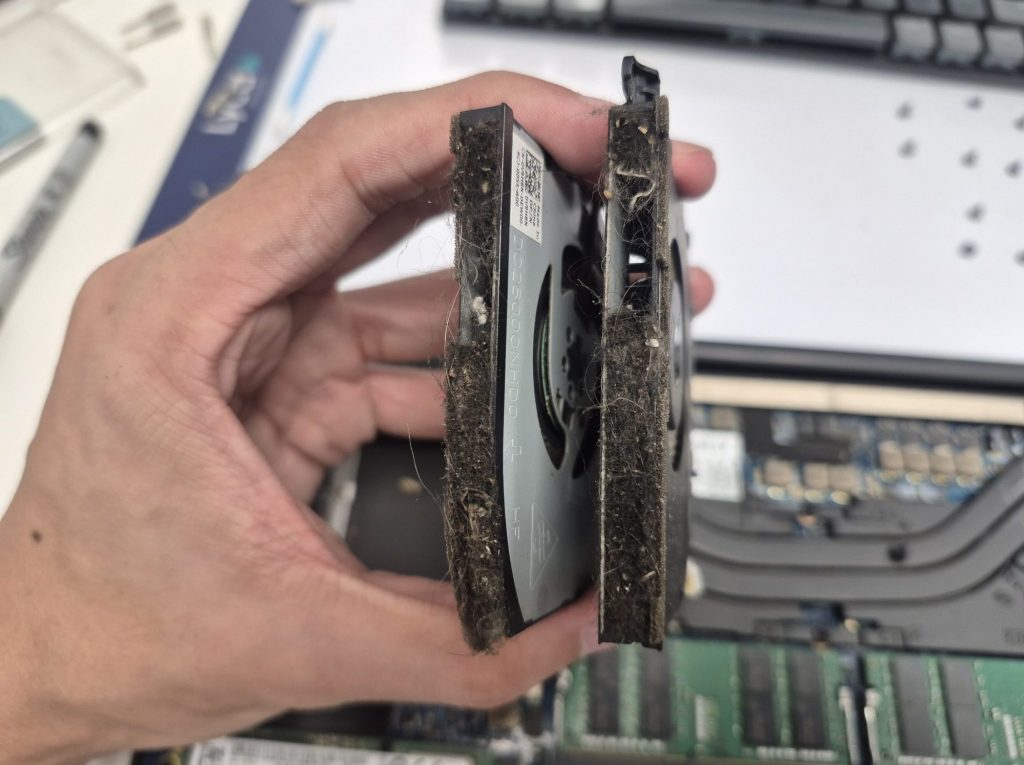 Dell XPS laptop fans air duct blocked with dust, pet hair, and other debris preventing airflow